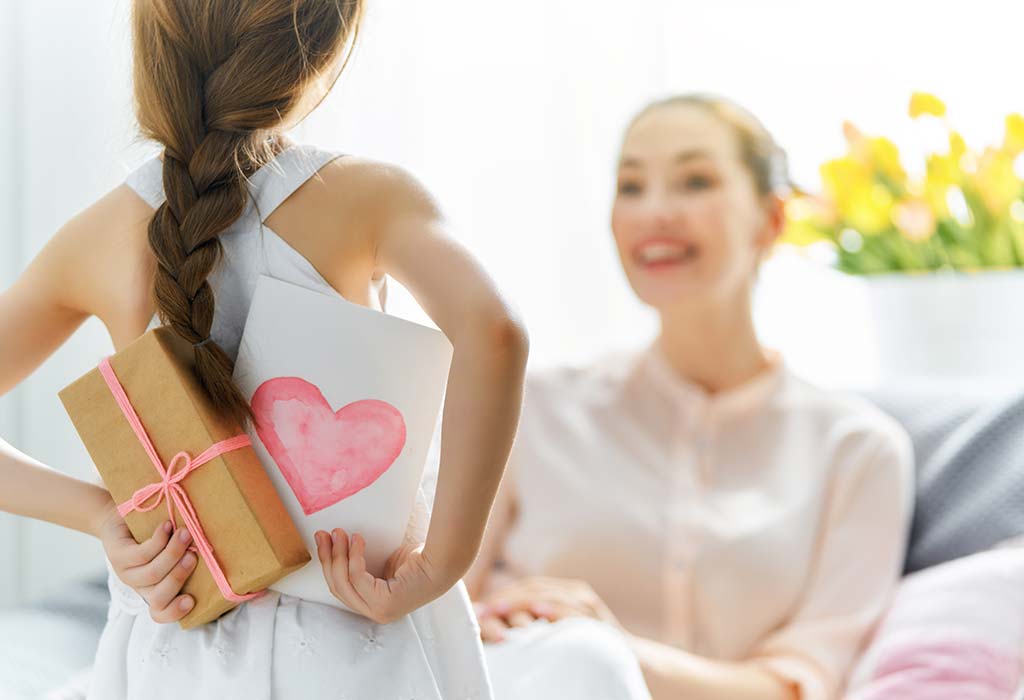 Girl giving card to mother
